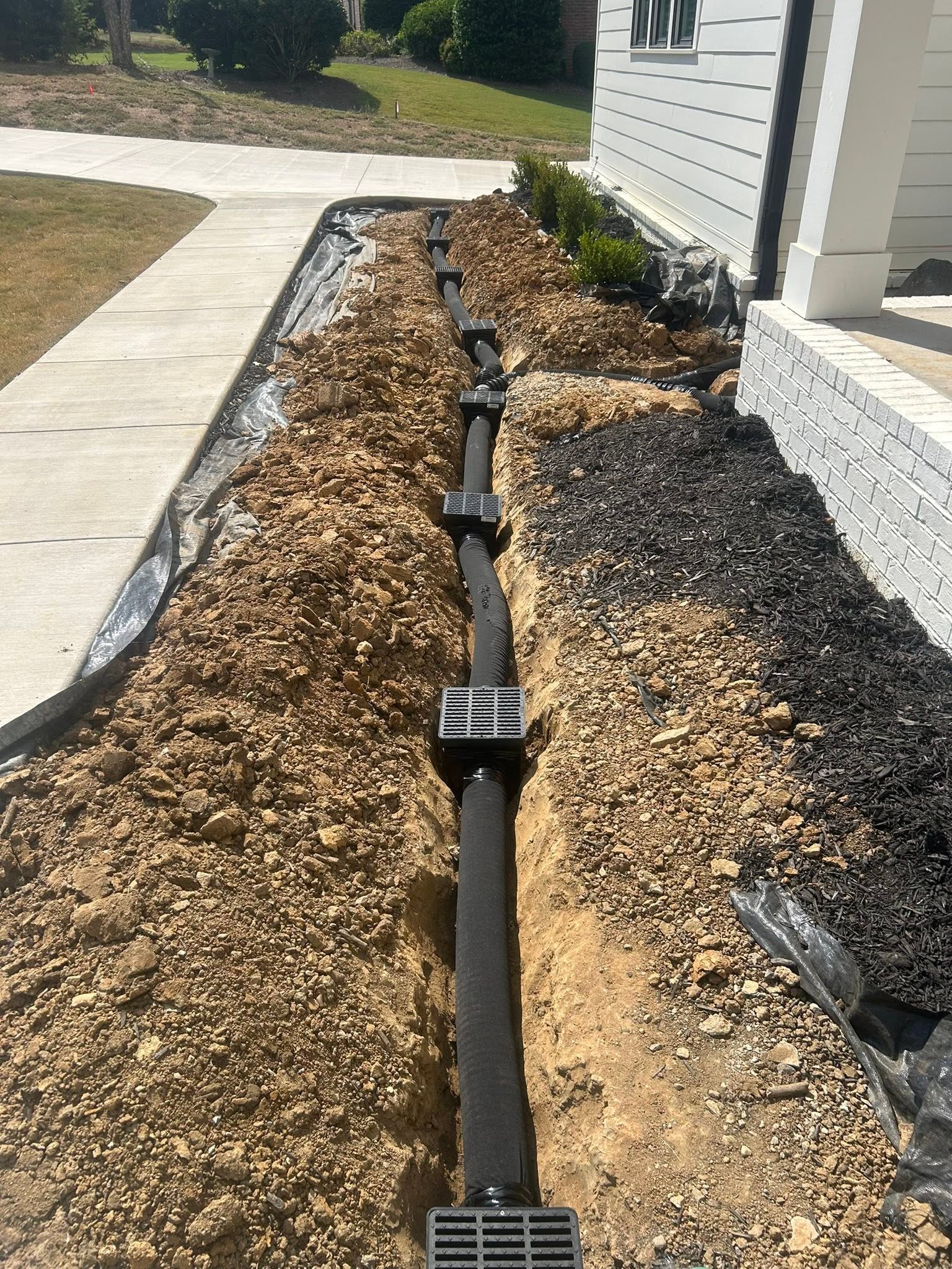 Backyard drainage trench with corrugated pipe