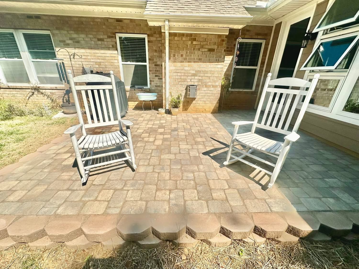 Stone walkway leading to a brick home